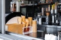 Many empty baked waffle cones and paper cups for ice cream stacked at display counter window of street food takeaway Royalty Free Stock Photo