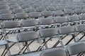 Many empty black folding chair rows