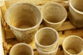 Many empty brown clay pots of different size in old textured wooden box on trade fair Horizontal, wallpaper and postcard Royalty Free Stock Photo
