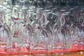 Many empty clean transparent wine glasses stand on a bar counter. Closeup Royalty Free Stock Photo