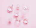 Many empty glasses on pink background. Top view, flat lay Royalty Free Stock Photo