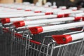 Many empty metal shopping carts, closeup view Royalty Free Stock Photo