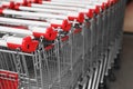 Many empty metal shopping carts near supermarket outdoors, closeup. Space for text Royalty Free Stock Photo