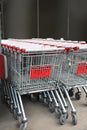 Many empty metal shopping carts near supermarket outdoors Royalty Free Stock Photo
