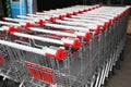 Many empty metal shopping carts near supermarket outdoors Royalty Free Stock Photo