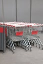 Many empty metal shopping carts near supermarket outdoors Royalty Free Stock Photo