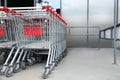 Many empty metal shopping carts near supermarket outdoors, space for text Royalty Free Stock Photo