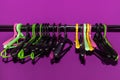 Many empty multi-colored plastic hangers hanging on a metal rack Royalty Free Stock Photo