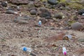 Many empty plastic bottle on the pebble beach Royalty Free Stock Photo