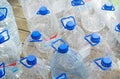 Many empty plastic gallons of drinking water on wooden background. Royalty Free Stock Photo