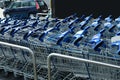 Many empty shopping carts near supermarket, closeup Royalty Free Stock Photo