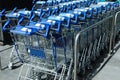 Many empty shopping carts near supermarket, closeup Royalty Free Stock Photo