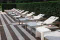 Many empty sunbeds near outdoor swimming pool at resort Royalty Free Stock Photo