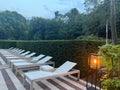 Many empty sunbeds near outdoor swimming pool at resort Royalty Free Stock Photo