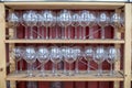 many empty wine glasses arranged on wooden shelves Royalty Free Stock Photo