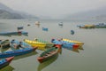 A many empty wooden colored boats on a smooth lake during the day against the backdrop of a mountain valley Royalty Free Stock Photo