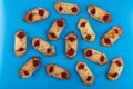 Many envelope cookies with jam on blue table. Top view