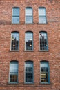 Many equal windows of the factory. Old red brick building or factory with many windows Royalty Free Stock Photo