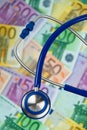 Many Euro bank notes with a stethoscope. Royalty Free Stock Photo