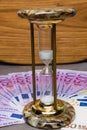 many 500 euro banknotes background with hourglass. EU currency