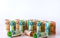 Many euro bills worth 100 and 50, folded into a roll one at a time, stand in a row. Free space Royalty Free Stock Photo