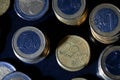 Many euro coins stacked on black Royalty Free Stock Photo