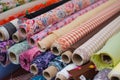 Many fabric rolls and colorful textiles at market