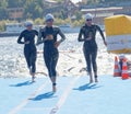 Many female swimmer climbing up from the water