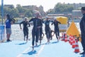 Many female swimmer climbing up from the water
