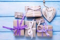 Many festive gift boxes with presents and decorative heart on b