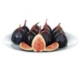 Many figs on a plate with cut fruit isolated on white Royalty Free Stock Photo