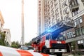 Many fire engine trucks with ladder and safety equipment at accident in highrise tower residential apartment or office Royalty Free Stock Photo