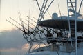 Many fishing rod on a boat at sunset