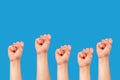 many fists on blue background Royalty Free Stock Photo