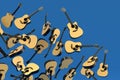 Many of flying acoustic guitars isolated on blue background.