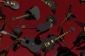 Many of flying electric guitars isolated on red background.