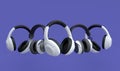 Many flying gamer gears like headphones on violet background