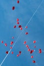Many flying red heart-shaped balloons in blue sky at wedding Royalty Free Stock Photo