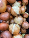 Many fresh brown onions on display at the market stand.