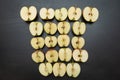 Many fresh halves of apples are laid out on a black table. top view