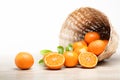 Many fresh oranges in a wooden basket placed on the floor. Royalty Free Stock Photo