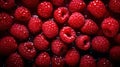 Many fresh perfect raspberries with water drops in top view on a dark background