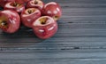Many fresh red apples placed on a plank table. 3D Rendering