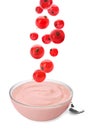 Many fresh red currant berries falling into glass bowl of yogurt on white background Royalty Free Stock Photo
