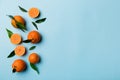 Many fresh ripe mandarin with green leaves on colored background, top view, space for text Royalty Free Stock Photo