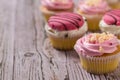 Many freshly prepared cupcakes on a wooden table. Royalty Free Stock Photo