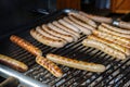 Many fried sausages on the charcoal grill, typical fast food in Germany on the street or at an open air festival Royalty Free Stock Photo