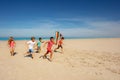 Many friends kids run with color kite on the beach Royalty Free Stock Photo