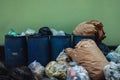 Many Garbages and Full Trash againt the Wall. Pollution Problem from not Waste Sorting Behaviour Royalty Free Stock Photo