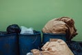 Many Garbages and Full Trash againt the Wall. Pollution Problem from not Waste Sorting Behaviour Royalty Free Stock Photo